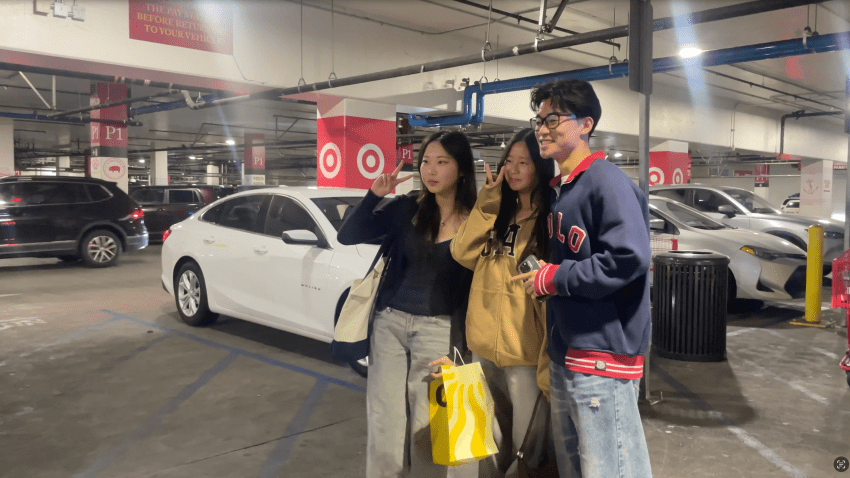 Eric Ou poses with fans at USC Village.